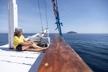 Indonesia, Komodo National Park, girl on a sailing boat