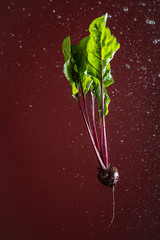gourd on a red background with water drops