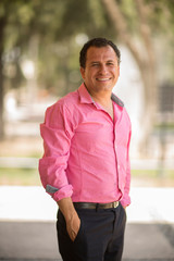 portrait of smiling young man in park