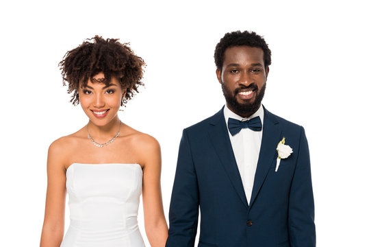 happy african american bride and bridegroom looking at camera isolated on white