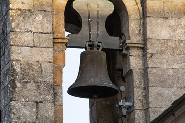 Fototapeta premium Ancient bell of a Spanish church in a bell tower in Spain, wooden and steel bell.