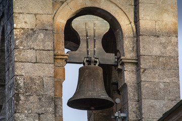 Obraz premium Ancient bell of a Spanish church in a bell tower in Spain, wooden and steel bell.