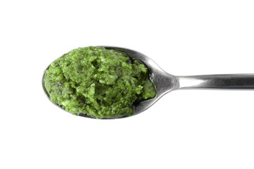 Spoon of tasty pesto sauce isolated on white, top view