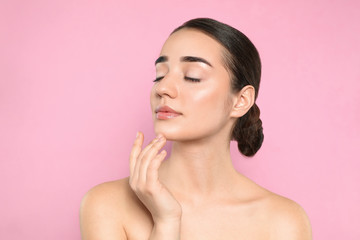 Fototapeta premium Portrait of young woman with beautiful face against color background
