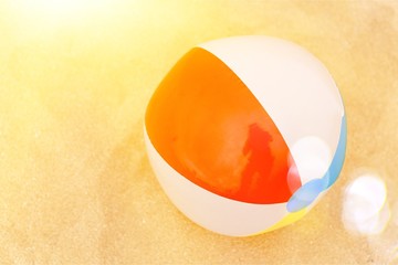 Background with a beach ball on the sand