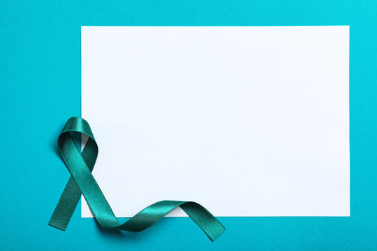 Teal ribbon and blank card on color background, top view. Space for text - Powered by Adobe