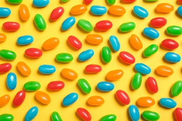 Flat lay composition with delicious jelly beans on color background
