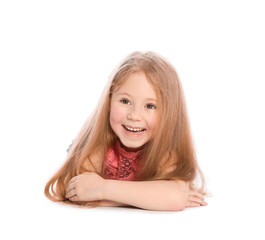 Happy little girl in casual outfit lying on white background