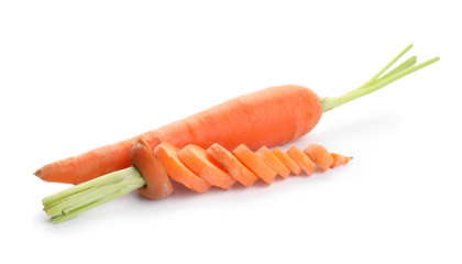 Whole and sliced ripe carrots on white background