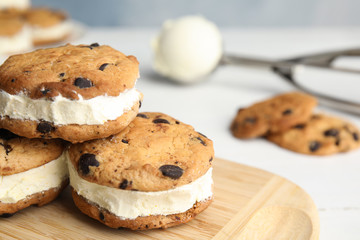 Sweet delicious ice cream cookie sandwiches on table, closeup. Space for text