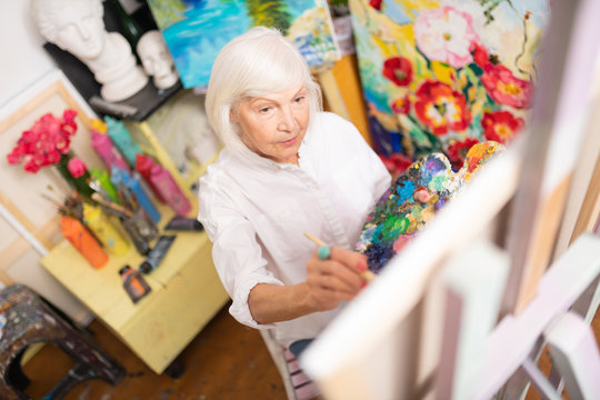 Retired woman loving painting coloring her picture