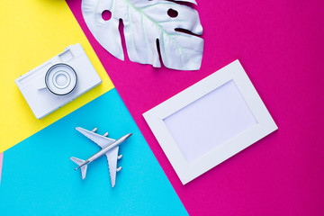 Travel objects flatlay on yellow, blue and red with copy space mockup