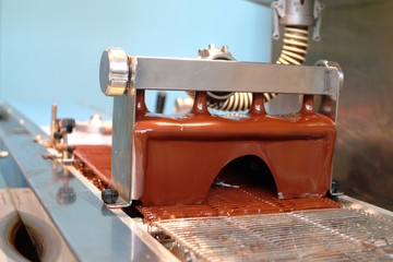 Pouring of liquid chocolate for the production of chocolates