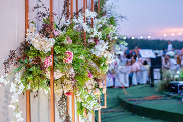 Wedding Ceremony with beautiful flowers in the evening with sunset light. Wedding setting concept.