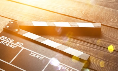 Open clap board on brown wooden table background