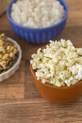 Ceramic bowl with popcorn on gray background