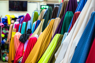 Colorful of many fabric rolls selling in market stall shop. Fashion desig concept.