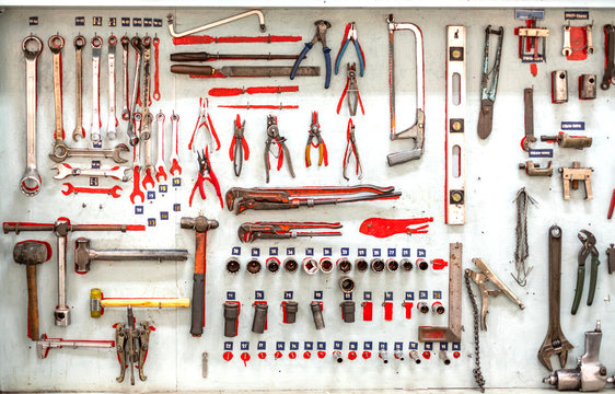 Set collection of professional mechanic tools hanging as background.