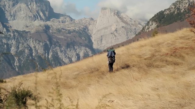 Hiking from the famous Valbona to Theth valley. Valbone to Thethi in the Albanian Alps. Man backpacking and camping in the mountains.