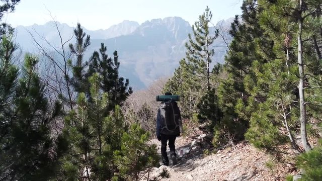 Hiking from the famous Valbona to Theth valley. Valbone to Thethi in the Albanian Alps. Man backpacking and camping in the mountains.