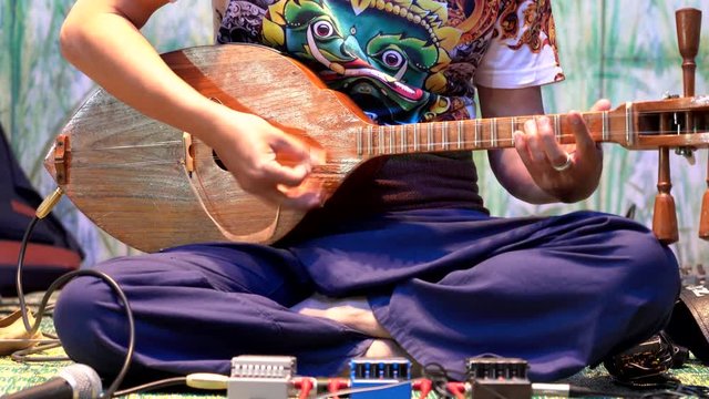 Man Strums Mandolay Close Up View of Hands.