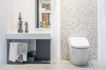 Naklejka na ściany i meble Bathroom interior with white wall, vintage furniture, towels, toilet and sink