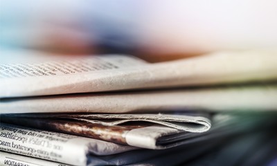 Fototapeta premium Pile of newspapers on background close up