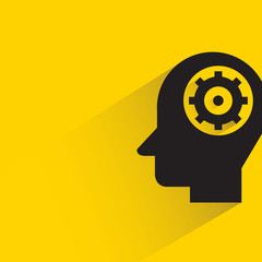 gear in human head with shadow on yellow background