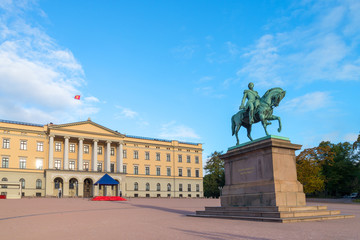 The equestrian statue of King Karl III Johan of Norway and Sweden stand in front of the Royal Palace with blue sky in morning summer. Oslo, Norway.  Text translation: The love of the people my reward. - 272740607