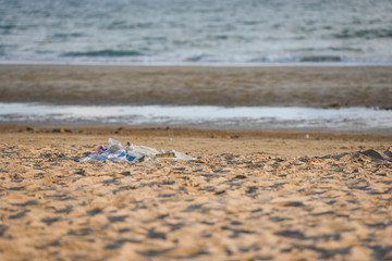 Garbage in the sea with bag plastic bottle and other garbage beach sandy dirty sea on the island / Environmental problem
