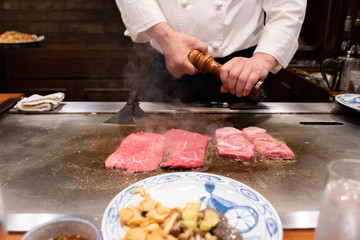 The chef is cooking a Japanese food style steak.