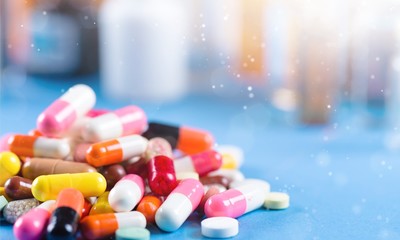 Colorful pills and tablets on background