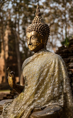 Ancient Stone Sitting Buddha With One Palm Raised.