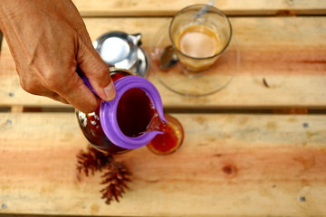 coffee drinks served on wooden tables with small glasses, with added pine decorations