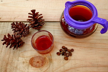 coffee drinks served on wooden tables with small glasses, with added pine decorations