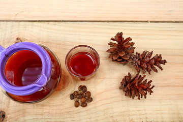 coffee drinks served on wooden tables with small glasses, with added pine decorations