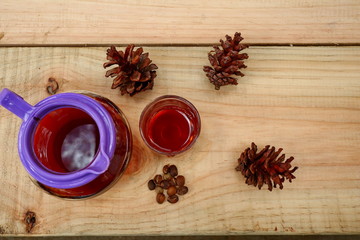coffee drinks served on wooden tables with small glasses, with added pine decorations