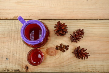 coffee drinks served on wooden tables with small glasses, with added pine decorations