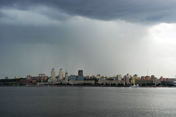 Ukraine. Dnieper. Thunderstorm approaching the city. Huge storm clouds, it is raining.