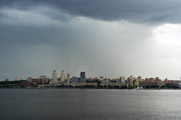 Fototapeta premium Ukraine. Dnieper. Thunderstorm approaching the city. Huge storm clouds, it is raining.
