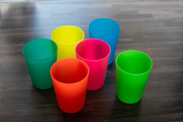 Colorful plastic cups on table