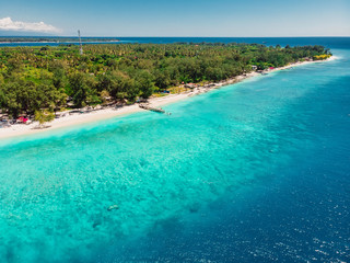 Fototapeta na wymiar Tropical beach with white sand and turquoise ocean. Aerial view. Paradise holiday resort