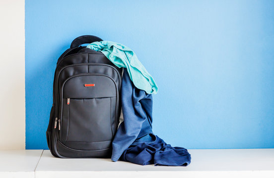 Black Backpack For Travel Keep The Clothes Full And Overflow. Black Backpack Placed On The Table, White Background