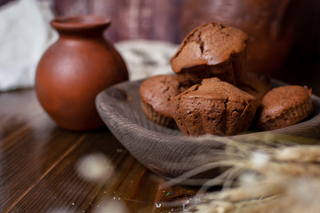 chocolate cupcakes in a wooden plate in the old style