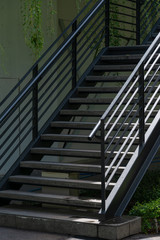 Stairway with black metallic banister in a new modern building architecture