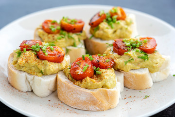 Homemade toast sandwich with avocado, cherry tomato and green dill on white bread, healthy food concept for breakfast