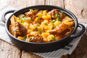 Served stew of short beef ribs with potatoes in a spicy sauce, closeup in a pot. horizontal