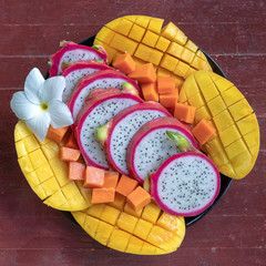 Tropical fruits assortment on a plate, close up