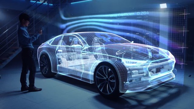Automotive Engineer Working on Electric Car Chassis Platform, Using Tablet Computer with Augmented Reality 3D Software. Innovative Facility: Vehicle Virtual Mesh Model is Tested for Aerodynamics.