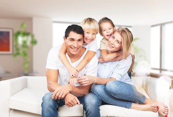 Young  family at home smiling at camera